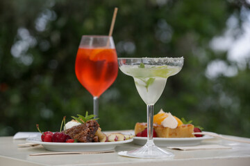 Cocktails and desserts on the table in the outdoor cafe