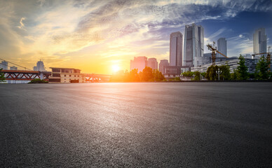 Clean asphalt road and city skyline in Chongqing at sunset