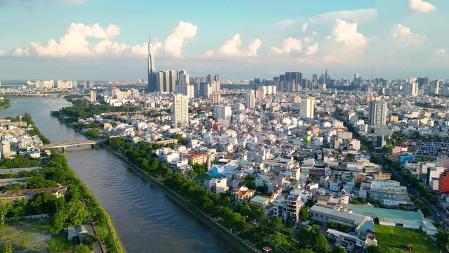 Panoramic view of Saigon, Vietnam from above at Ho Chi Minh City's central business district. Cityscape and many buildings, local houses, bridges, rivers