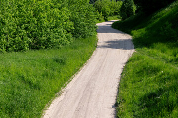 a narrow country road in the summer