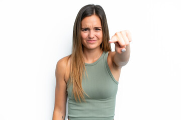 Young caucasian woman isolated on white background frustrated and pointing to the front