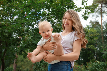 Mother with her cute baby spending time together outdoors