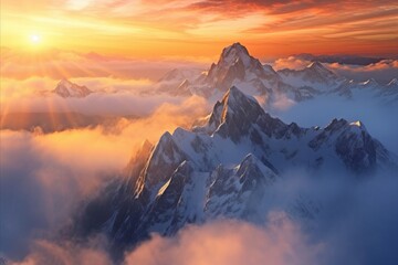 Aerial view of sunrise over snowy mountains, foggy and cloudy, clouds, mountain peaks, snow-covered mountains