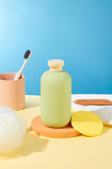 On a podium, a sleek shower gel bottle shares space with a sponge and a towel, transforming the scene into a well-appointed bathroom corner enriched with essential personal care items.