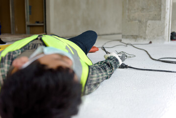Work accident electric short circuit to a worker in the workplace and Unconscious lying on the...