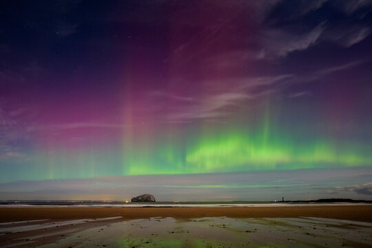 UK, Scotland, Aurora borealis over Seaclif beach at night