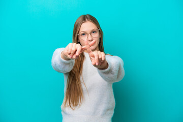 Young Russian woman isolated on blue background making stop gesture with her hand to stop an act