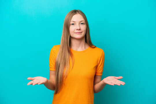 Young Russian woman isolated on blue background having doubts