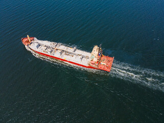 Cement carrier ship in transit in sea, maritime shipping. Aerial view