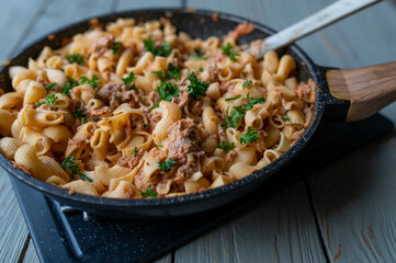 Creamy tuna with pasta and parmesan cheese isolated in a skillet. Cooked with shell noodles.