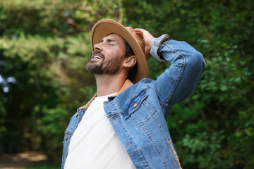 Feeling freedom. Smiling man enjoying nature outdoors