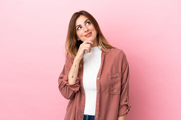 Caucasian woman isolated on pink background and looking up
