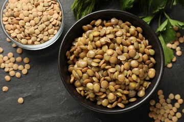 Delicious lentils in bowls on grey table, flat lay