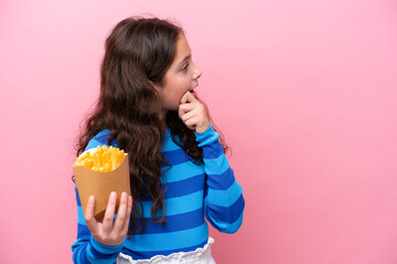 Little caucasian girl celebrating a birthday isolated on white background thinking an idea and...