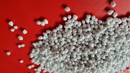 White masterbatch compounds on a red background