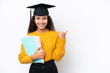 Arab university graduate woman holding books isolated on white background pointing to the side to...