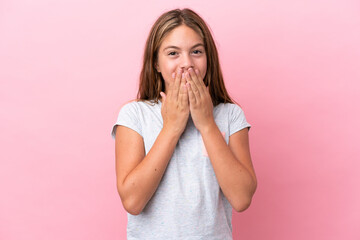 Little caucasian girl isolated on pink background happy and smiling covering mouth with hands