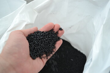 Black polymer granules in the palm