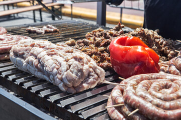 Street food with huge barbecue with many cuts of different meat of traditional Italian and Sicilian...