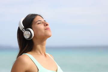 Woman meditating with headphone listening guide