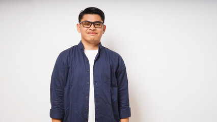 Smiling young Asian man wearing casual shirt on white background. studio shot