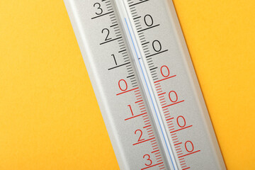 Modern weather thermometer on yellow background, closeup