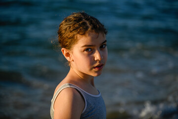 Fototapeta na wymiar Isolated close up portrait of a young girl in a natural sunset light- Israel