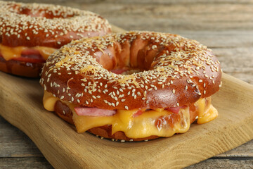 Delicious bagels with ham and cheese on table