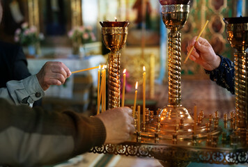 Orthodox Church. Parishioners lighting and placing candles. Candles are lit for repose.