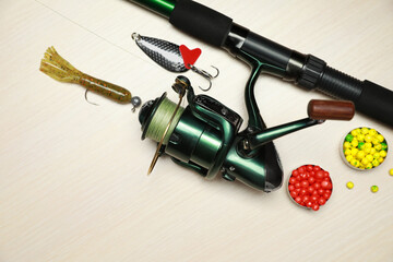 Fishing tackle on wooden background, flat lay. Space for text