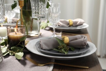 Beautiful table setting with candle and floral decor