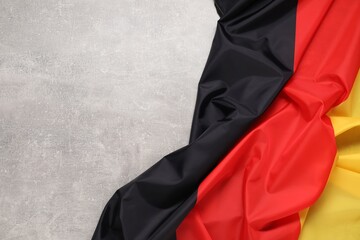 Flag of Germany on light gray textured background, top view. Space for text