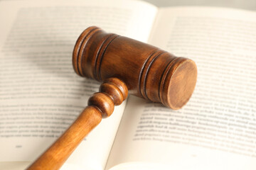 Law concept. Wooden gavel and book, closeup