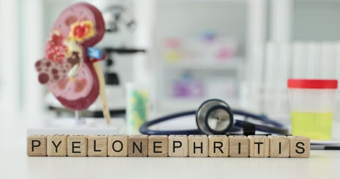 Pyelonephritis inscription on wooden cubes on the table in the hospital, close-up. Kidney disease, infection