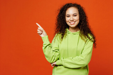 Smiling cheerful satisfied young woman of African American ethnicity wear green hoody casual...