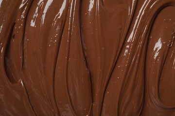 Tasty milk chocolate paste as background, top view