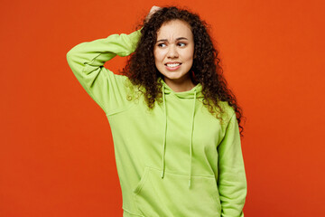Young sad confused mistaken dissatisfied woman of African American ethnicity she wear green hoody...