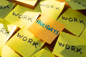 Many Post it with the word work and one in the center with the word holidays. Vacation time