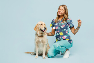 Full body young veterinarian woman wearing uniform stethoscope heal exam hug embrace retriever dog...
