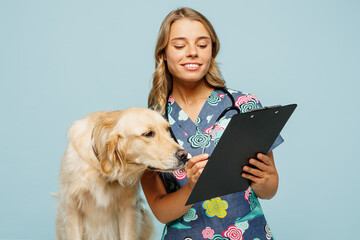 Young veterinarian woman she wear uniform stethoscope heal exam hug embrace retriever dog hold...