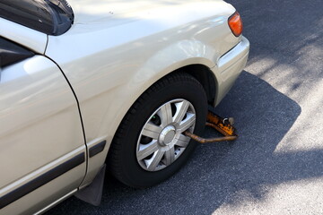 Car wheel locked illegal parking violation area, Bangkok, Thailand.
