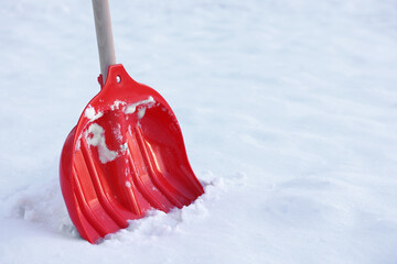 Snow shovel with wooden handle outdoors. Space for text