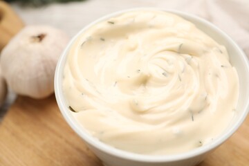 Tasty garlic sauce in bowl on table, closeup