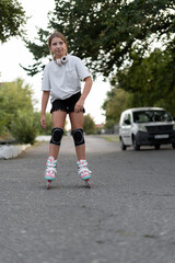Rollerblading concept. Teen girl roller skates during inline skating outdoors. Children active...