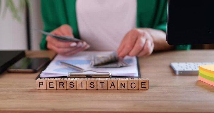 Persistence inscription on wooden cubes, close-up. Financial profit, career, overcoming obstacles