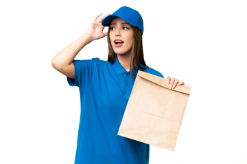 Young beautiful caucasian woman taking a bag of takeaway food over isolated background doing surprise gesture while looking to the side