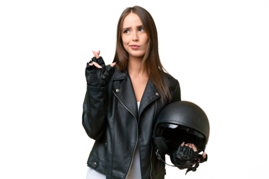 Young pretty caucasian woman with a motorcycle helmet over isolated background with fingers crossing and wishing the best
