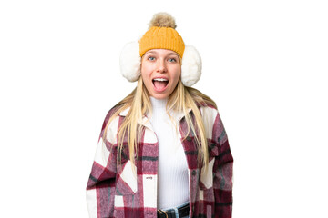 Young pretty blonde woman wearing winter muffs over isolated chroma key background with surprise...