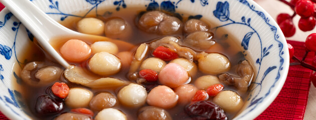 Homemade red and white tangyuan with syrup soup, dried longan pulp, red dates for Winter solstice.