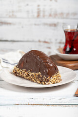 Chocolate and banana cake. Malaga cake on wooden background. Large chocolate eclairs